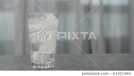 soda in glass with ice cubes on concrete countertop soda in glass with ice cubes on concrete countertop 63301464