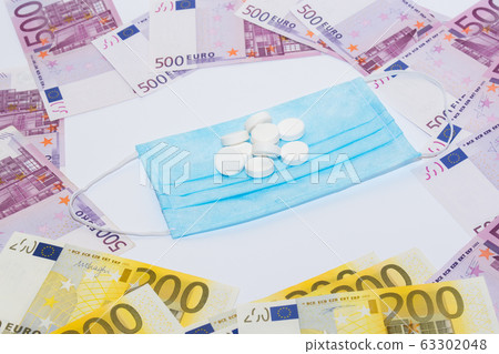 Tablets, protective medical mask and euro bills. Expensive medicine concept. Tablets, protective medical mask and euro bills. Expensive medicine concept. 63302048