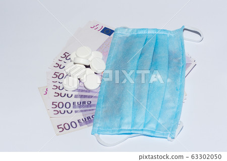Tablets, protective medical mask and euro bills. Expensive medicine concept. Tablets, protective medical mask and euro bills. Expensive medicine concept. 63302050