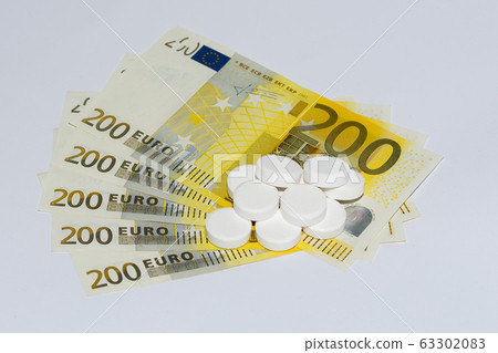 Tablets and euro bills. Expensive medicine concept. Tablets and euro bills. Expensive medicine concept. 63302083