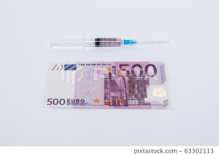 Syringe vaccine and euro bills. Expensive medicine concept. Syringe vaccine and euro bills. Expensive medicine concept. 63302113