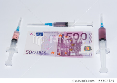 Syringe vaccine and euro bills. Expensive medicine concept. Syringe vaccine and euro bills. Expensive medicine concept. 63302125