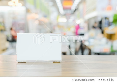 Mockup menu frame on counter bar table , Stand for booklets with advertising promotion recommended menu on blurred interior restaurant or coffee shop background clipping path on acrylic frame 63303110