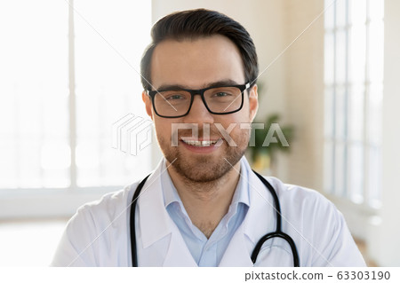 Head shot close up smiling male doctor therapist in eyeglasses. 63303190