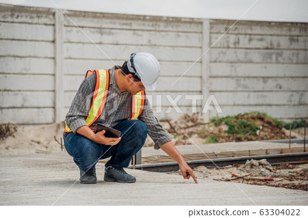 Man construction engineer at construction site Man construction engineer at construction site 63304022