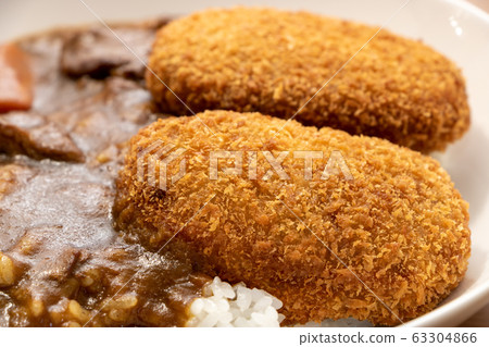 Croquette on curry and rice. 63304866