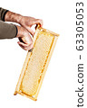 honey cutter in honeycombs with a wooden frame on 63305053