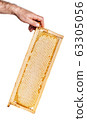 honey cutter in honeycombs with a wooden frame on 63305056