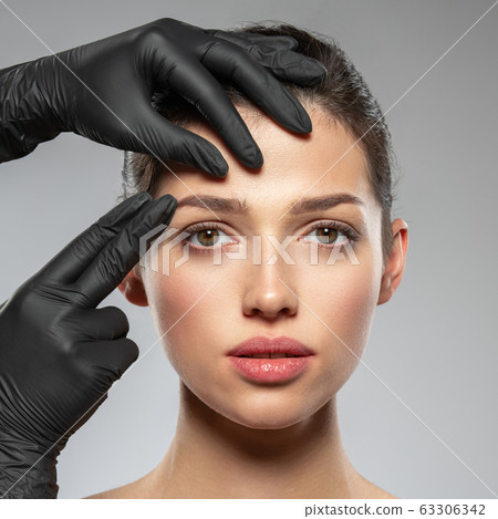 Face skin check before plastic surgery. Beautician Face skin check before plastic surgery. Beautician 63306342
