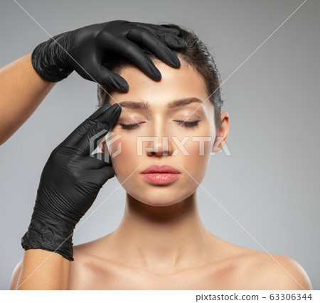 Face skin check before plastic surgery. Beautician 63306344