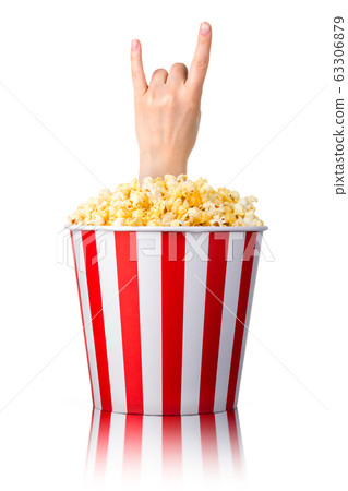 Female hand sticks out of a bucket with popcorn isolated on white background Female hand sticks out of a bucket with popcorn isolated on white background 63306879