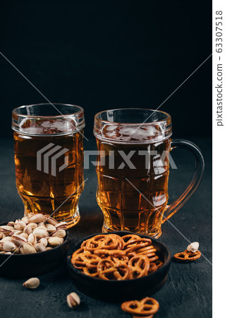 Beer, salted nuts and crunchy snacks. Beer, salted nuts and crunchy snacks. 63307518