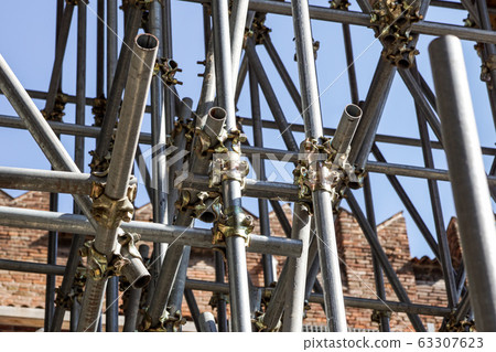 Scaffolding pipe clamp and parts, An important part of building strength to scaffold clamps in used close up on construction site,platforms for stage structure support 63307623