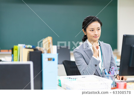 Teacher thinking in staff room 63308578