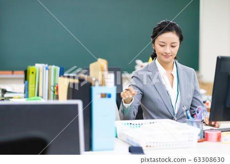 中年老師在職員室看文件 63308630