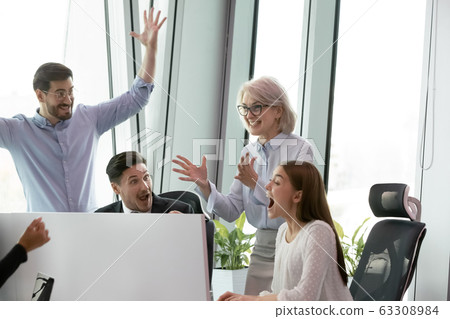 Overjoyed colleagues have fun celebrating success in office 63308984