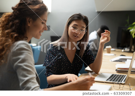 Serious Asian businesswoman mentor teaching trainee, giving instructions 63309307