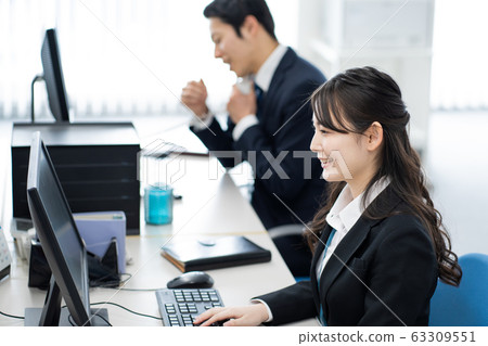A young woman headed to a computer 63309551
