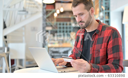Shopping, Online Payment on Laptop by Beard Young Man 63310898