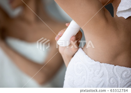 Close up focus on deodorant, applied under arm. Close up focus on deodorant, applied under arm. 63312784