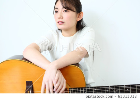 Woman with acoustic guitar Woman with acoustic guitar 63313318