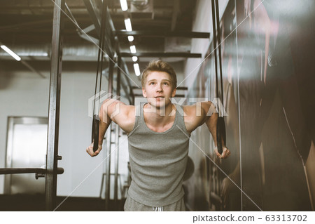 Sports Man Training With Gymnastics Rings At Gym 63313702