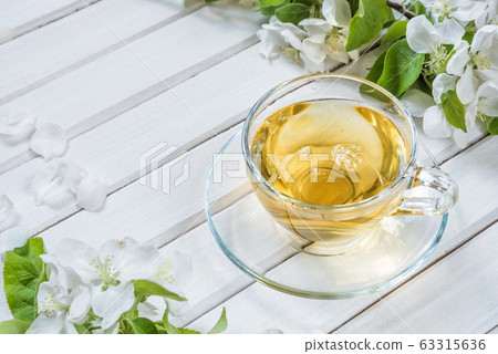 Spring green tea in glass cup 63315636