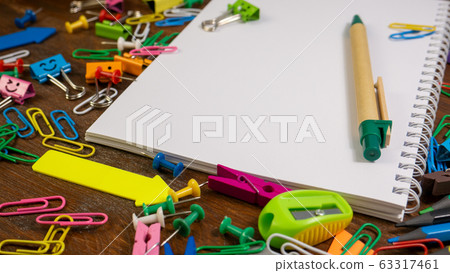 Office supplies on brown wooden table background Office supplies on brown wooden table background 63317461