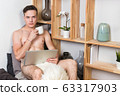 Naked sexy guy works at home with laptop 63317903