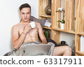 Naked sexy guy works at home with laptop 63317911