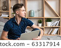 Young happy freelancer works at home with laptop 63317914