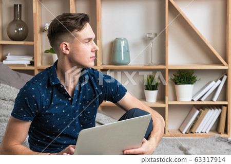Young happy freelancer works at home with laptop 63317914