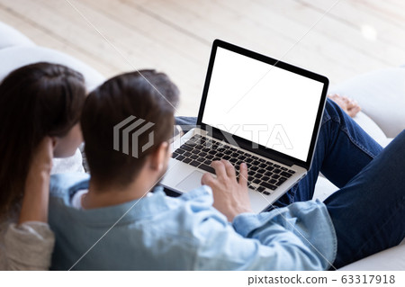 Loving couple looking at laptop screen blank white mockup 63317918