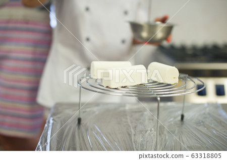 Creamy mousse dessert on a stand. The process of making dessert 63318805