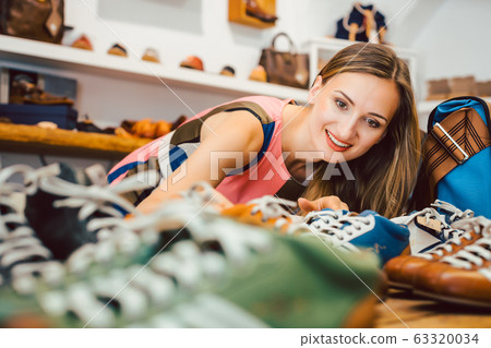 Woman in shoe store Woman in shoe store 63320034