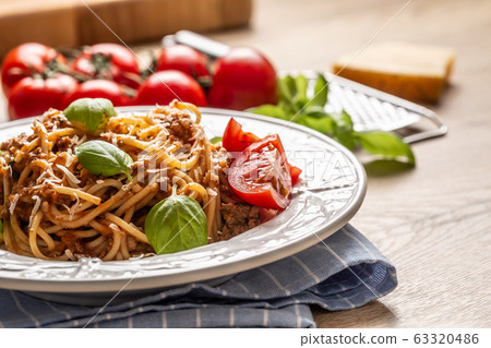 Italian pasta spaghetti bolognese served on white 63320486