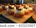Strawberry and Raspberry cupcakes on wooden background 63323567