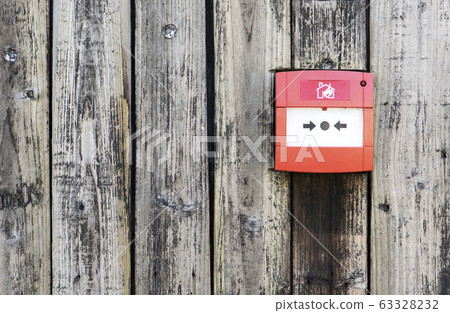 Red Fire alarm on the wooden wall background Red Fire alarm on the wooden wall background 63328232