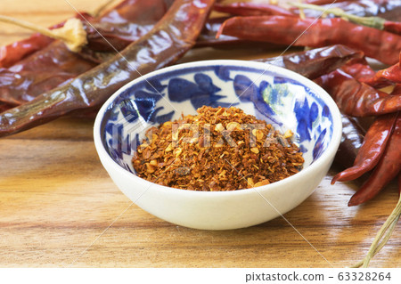 Cayenne pepper spice on wooden table Cayenne pepper spice on wooden table 63328264