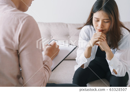 women Asian patients with man psychologist examination consulting and In psychotherapy women Asian patients with man psychologist examination consulting and In psychotherapy 63328507