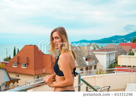 Beautiful tanned woman portrait at resort with beautiful view 63331296