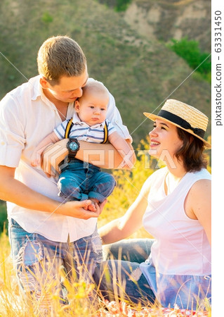 Family with baby at summer sunset. Family with baby at summer sunset. 63331450