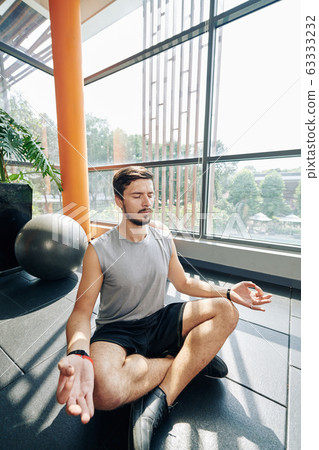 Calm man meditating Calm man meditating 63333232