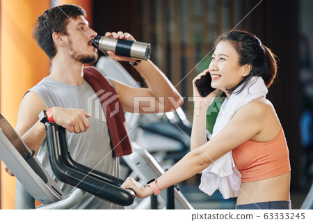 Happy training woman calling on phone Happy training woman calling on phone 63333245