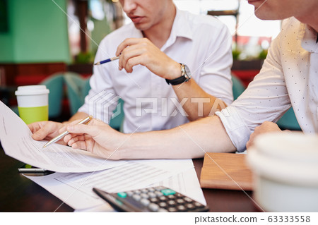 Entrepreneurs discussing documents Entrepreneurs discussing documents 63333558