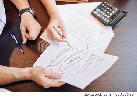 Businessmen checking partnership agreement Businessmen checking partnership agreement 63333559