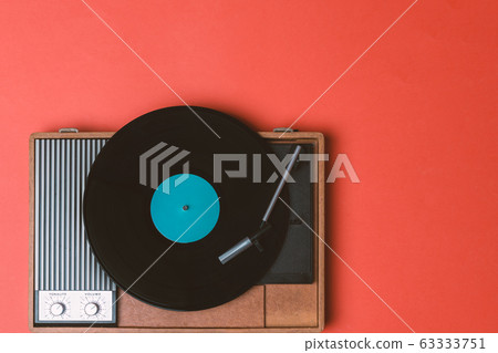 Vintage vinyl player and turnable on a orange 63333751