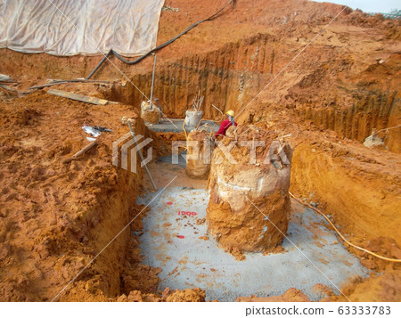 Bore pile cut to level by the construction workers. It will continue by pile cap and ground beam works. Bore pile cut to level by the construction workers. It will continue by pile cap and ground beam works. 63333783