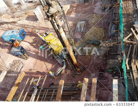 Bore pile driving work by bore pile rig at the construction site. The machine used to driven pile for building foundation wo 63333847