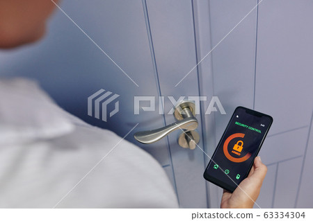 Woman using security control app Woman using security control app 63334304